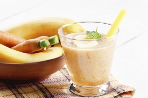 Carrot and banana shake on white table. Smoothie concept